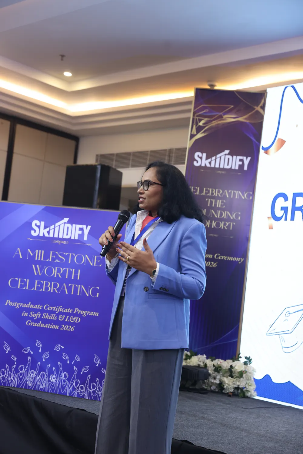Cynthia speaking on stage at the Skilldify graduation ceremony